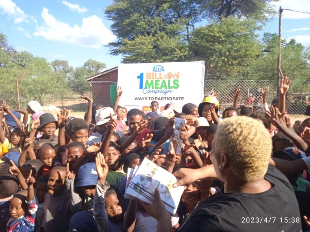 Volunteers from Gaborone 1 Chapter distributing food during Easter outreach event in Werda, Botswana
